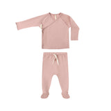 Pink baby outfit with long-sleeve top and footed pants on a white background