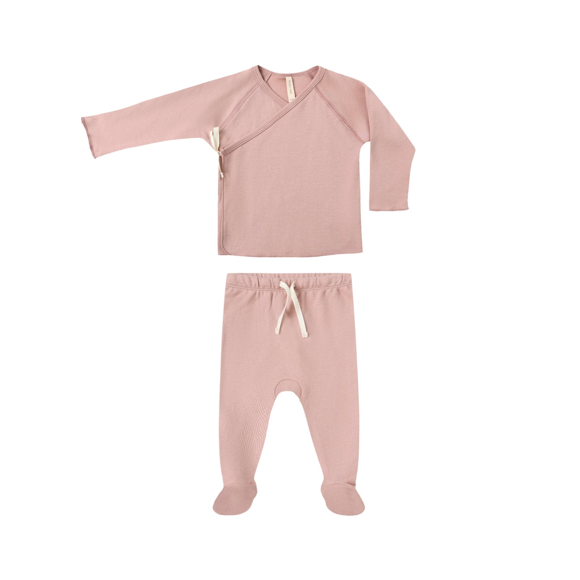 Pink baby outfit with long-sleeve top and footed pants on a white background